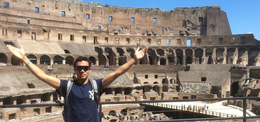 A Yale Student stands in front of the Colosseum in Rome