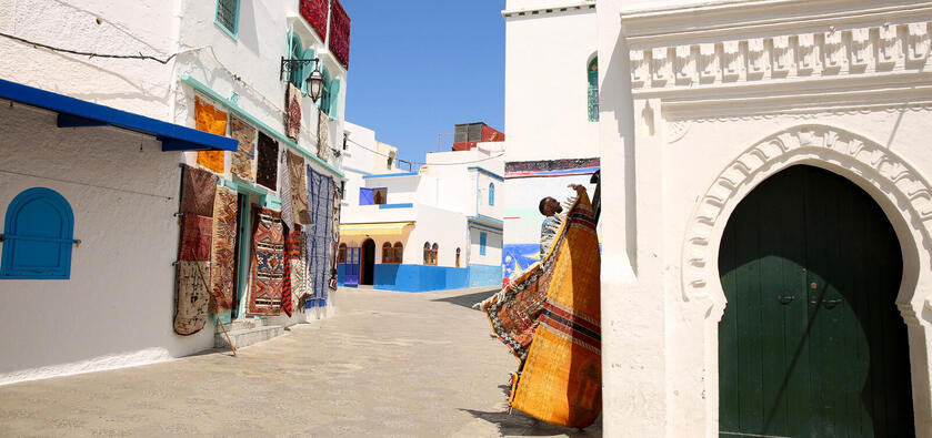 Alley with white architecture with splashes of color.