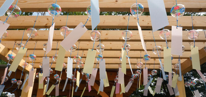 Wind chimes hung from wooden planks.