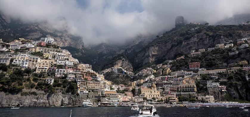 A view of mountains with buildings built up the sides of them overlooking a bay