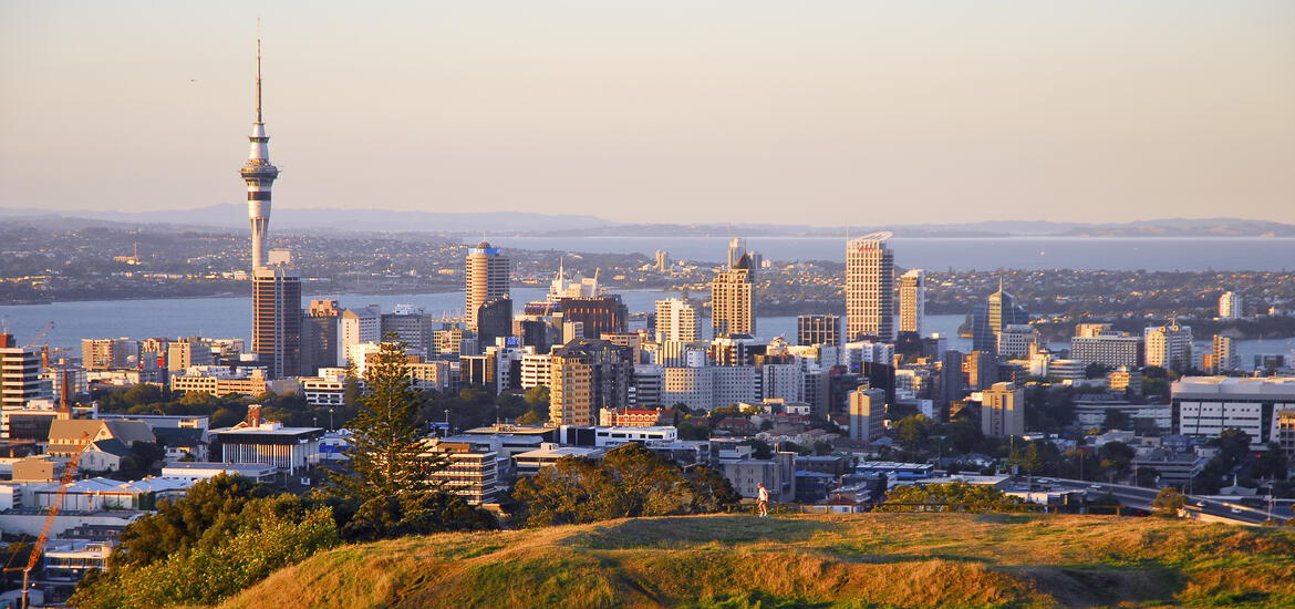 A view of the Auckland skyline at sunset, featuring the Sky Tower, seen from the summit of Mount Eden Volcano