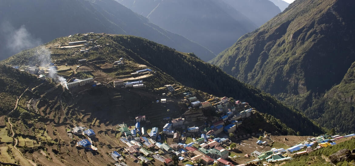 An aerial view of Namche Bazaar village in the Solukhumbu District of Nepal, nestled in the mountains with terraced landscapes