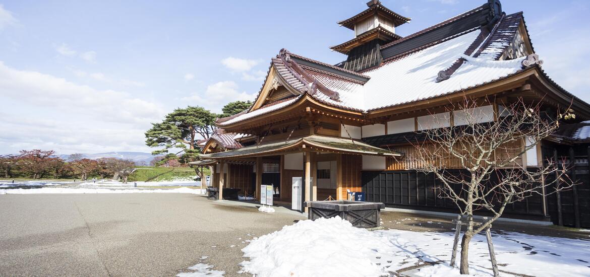 A traditional Japanese building with snow-covered rooftops at Goryokaku Tower in Hakodate, Hokkaido, Japan