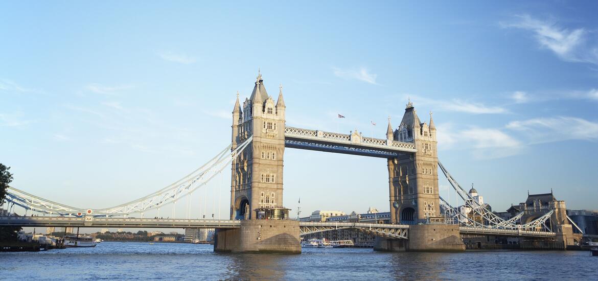 A view of iconic Tower Bridge in London spanning the River Thames, with its twin towers and suspension design