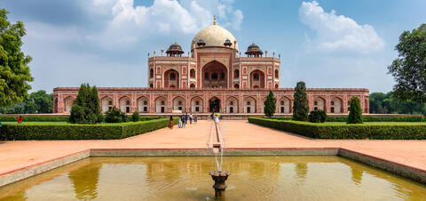 A large, red brick tomb with a white dome, called Humayun's Tomb, in New Delhi, India