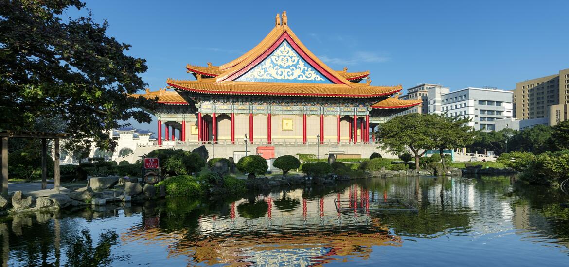 The National Concert Hall at Chiang Kai-Shek Memorial Hall Square in Taiwan, featuring traditional Chinese architecture with vibrant red pillars and an beautifully designed roof