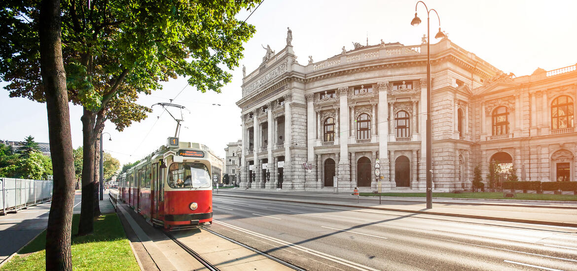 A red and white tram passing the neoclassical Burgtheater on Vienna’s Ring Road