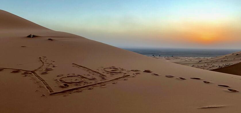 A sand dune with the word 